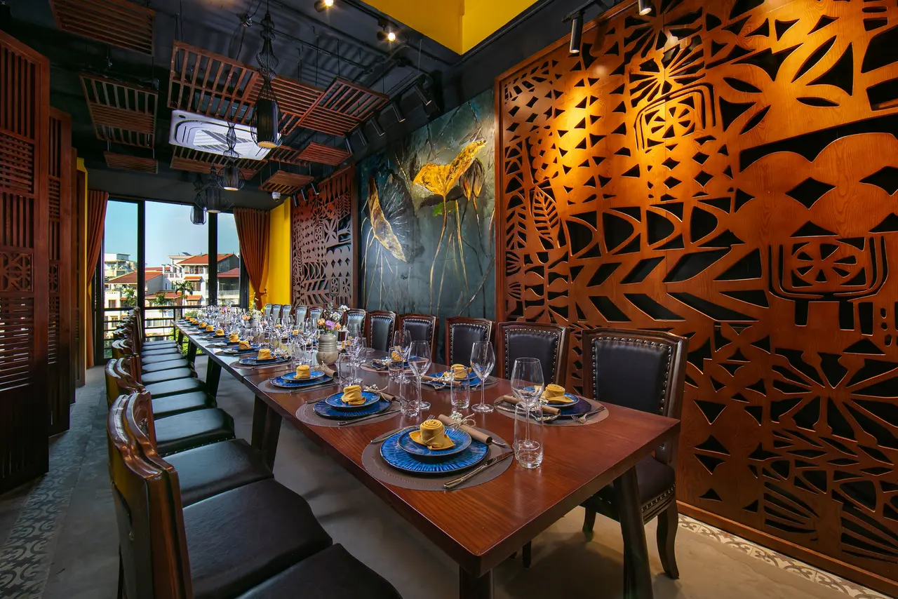 Dining room with large carved wooden screens and a long table
