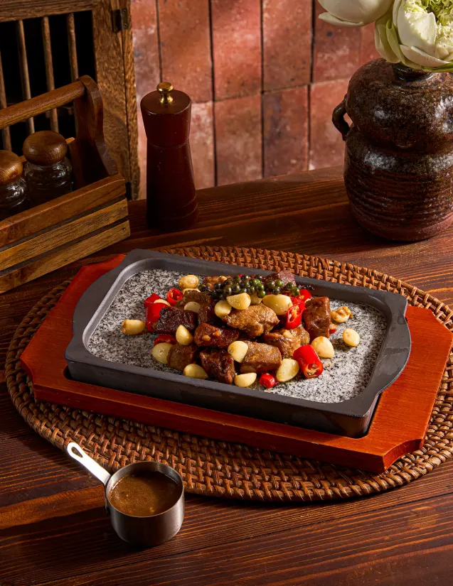 Beef with garlic and chilli on a hot stone plate